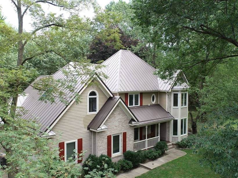 Two story home with a turret in St Joseph, Michigan and a standing seam metal roof