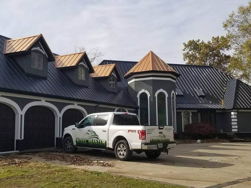 Steel Master Roofing truck parked at a finished metal roof job in Elkhart, Indiana