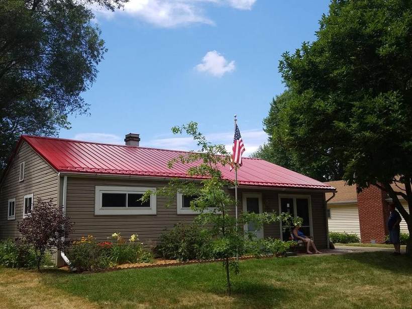 Ranch home in Niles, Michigan with a red metal roof