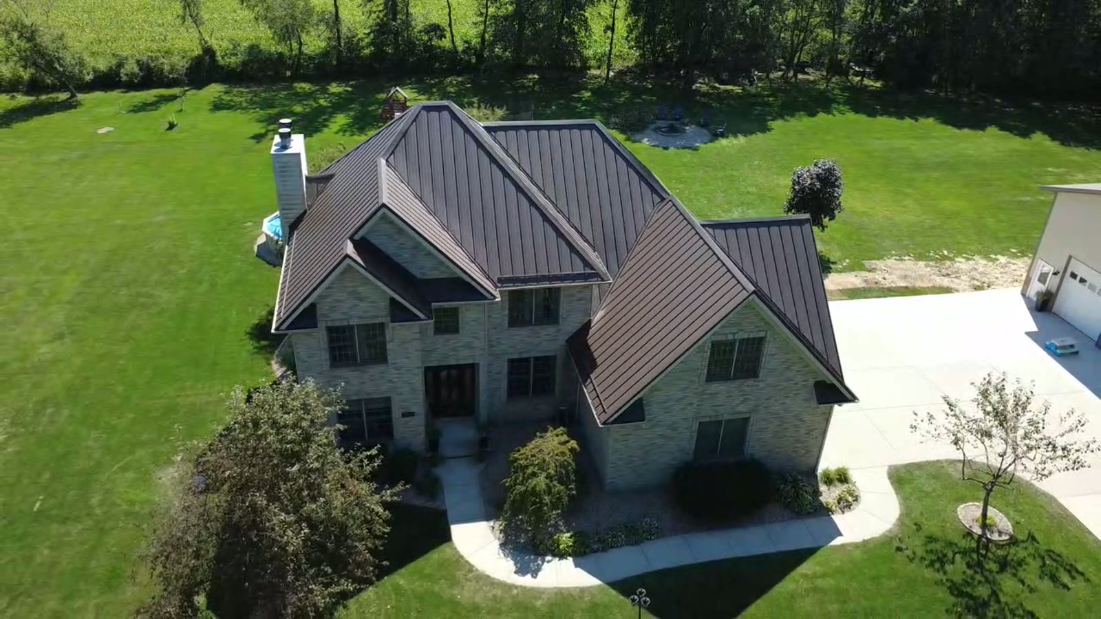 Aerial drone view of a completed Burnished Slate standing seam metal roof by Steel Master Roofing in Michiana