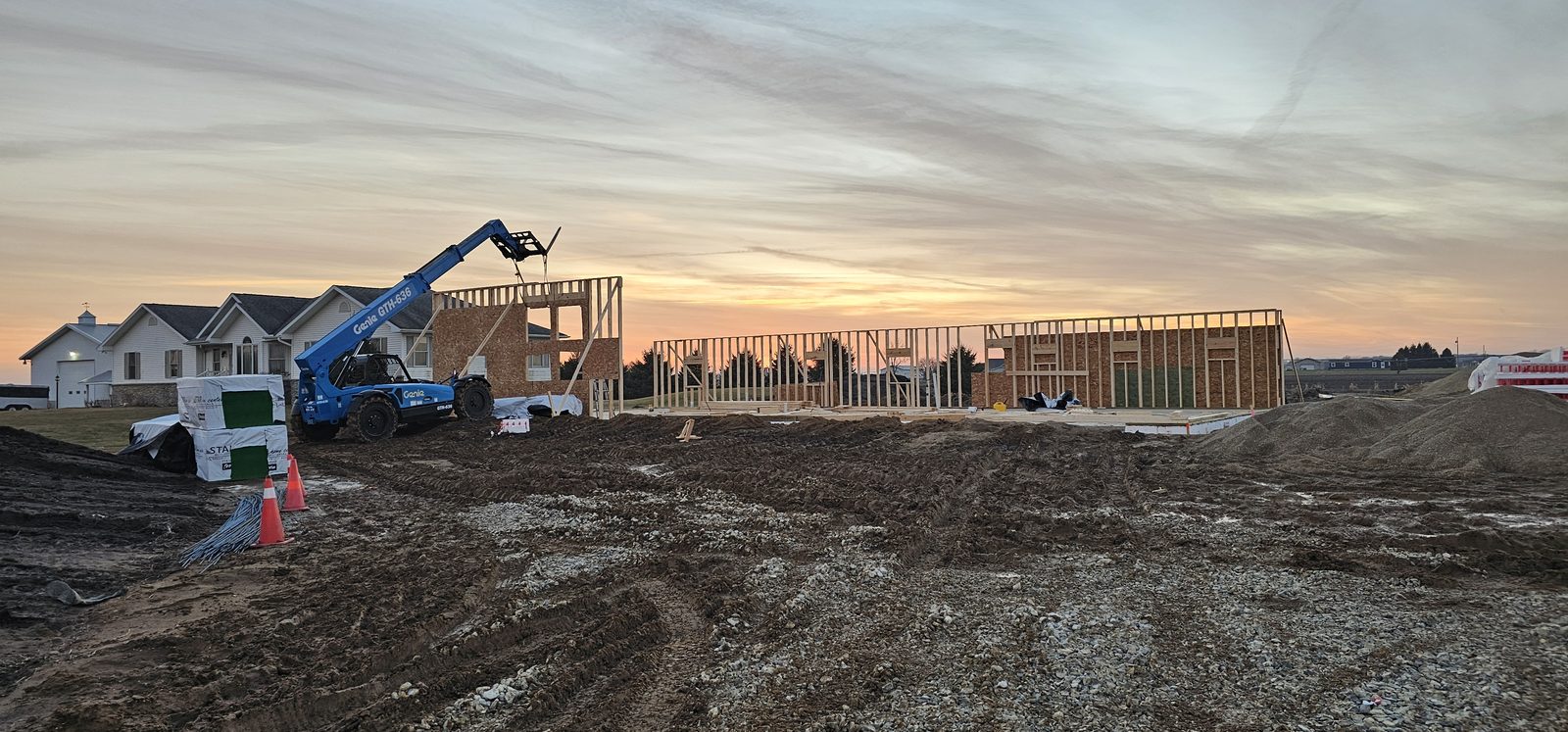 Barndominium barndominium framed at sunset with metal roof panels installed