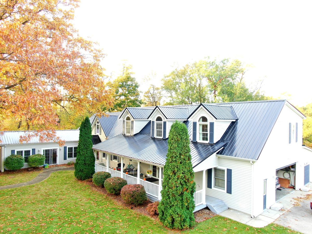 Cape cod home with dormers in Michiana with a charcoal Masterrib exposed fastener metal roof